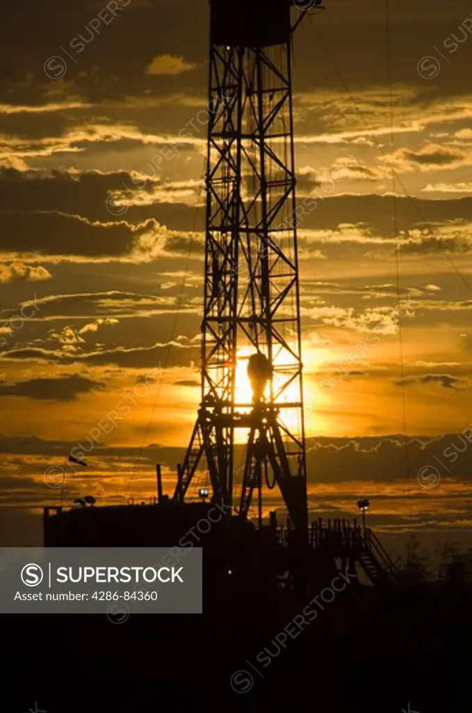 Sunset in west Texas at drilling rig.