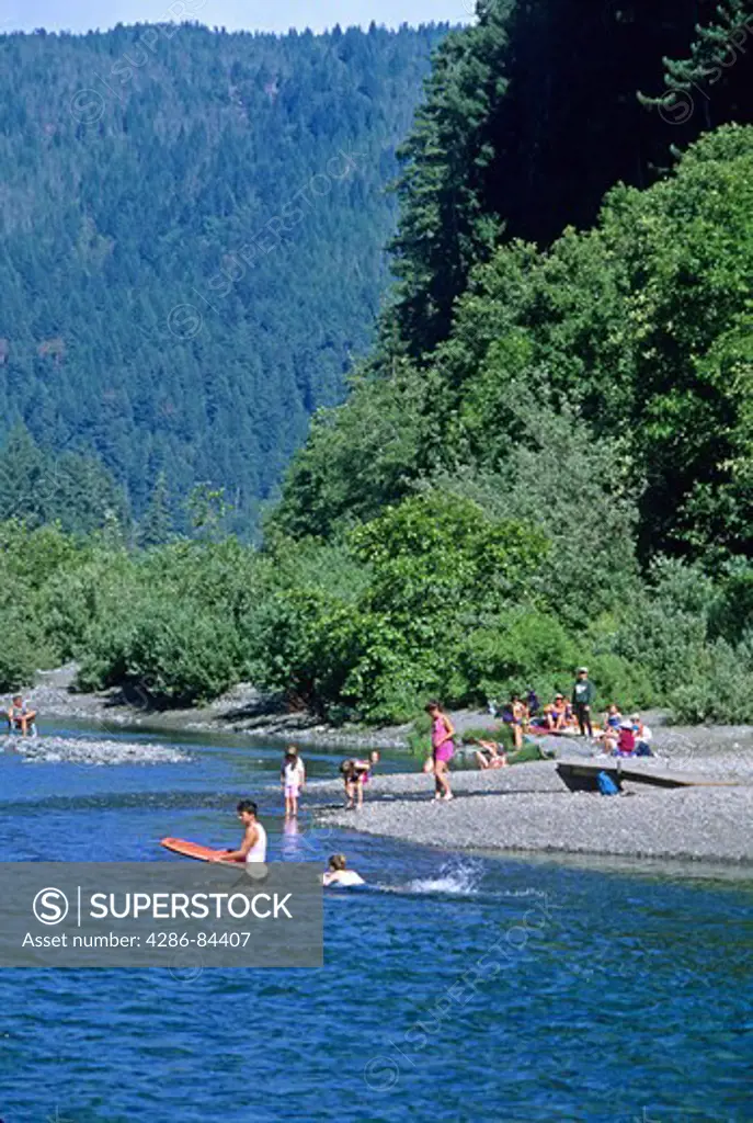 People swimming in Smith River in Jedediah Smith Redwoods State Park California