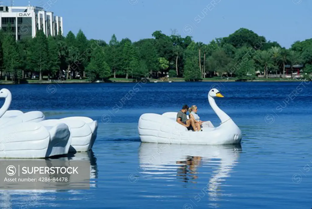 Couple peddling swan boat Lake Eola Orlando Florida
