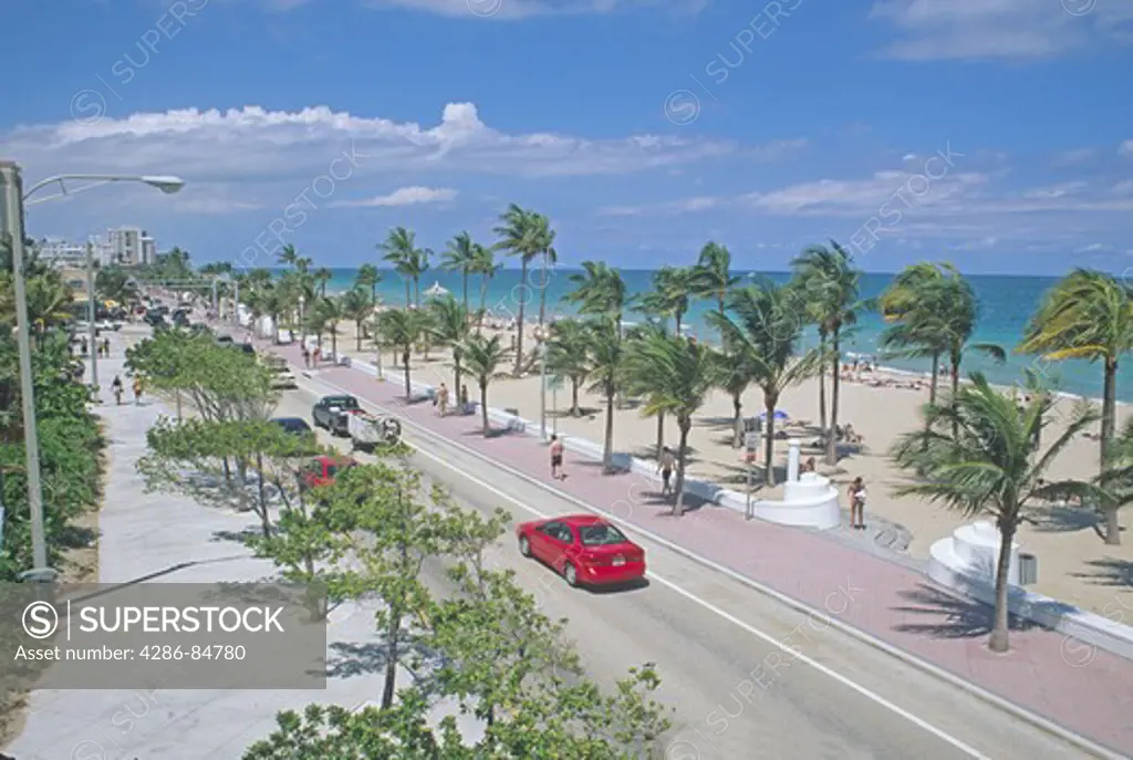Street along beachfront Fort Lauderdale Florida with people cars and activity