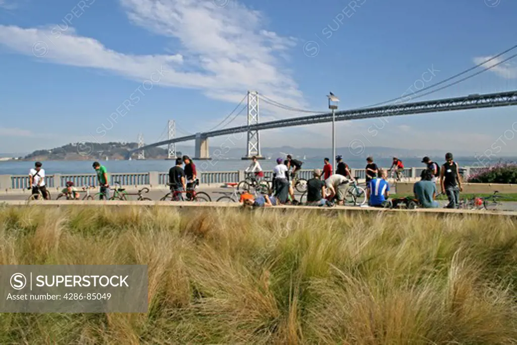 People along waterfront of Embarcadero near Bay Bridge San Francisco California