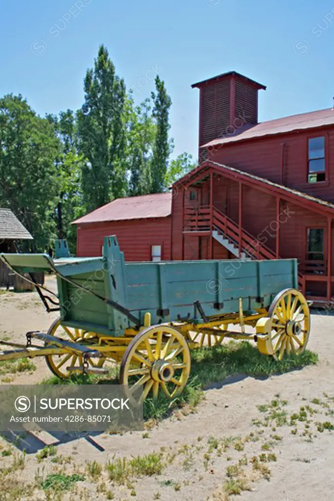 Old wagon parked near firehouse in historic Columbia State Historic Park Mother Lode gold rush town in California