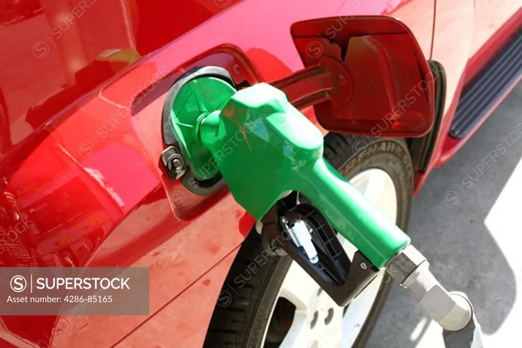 bright green gas pump in red car