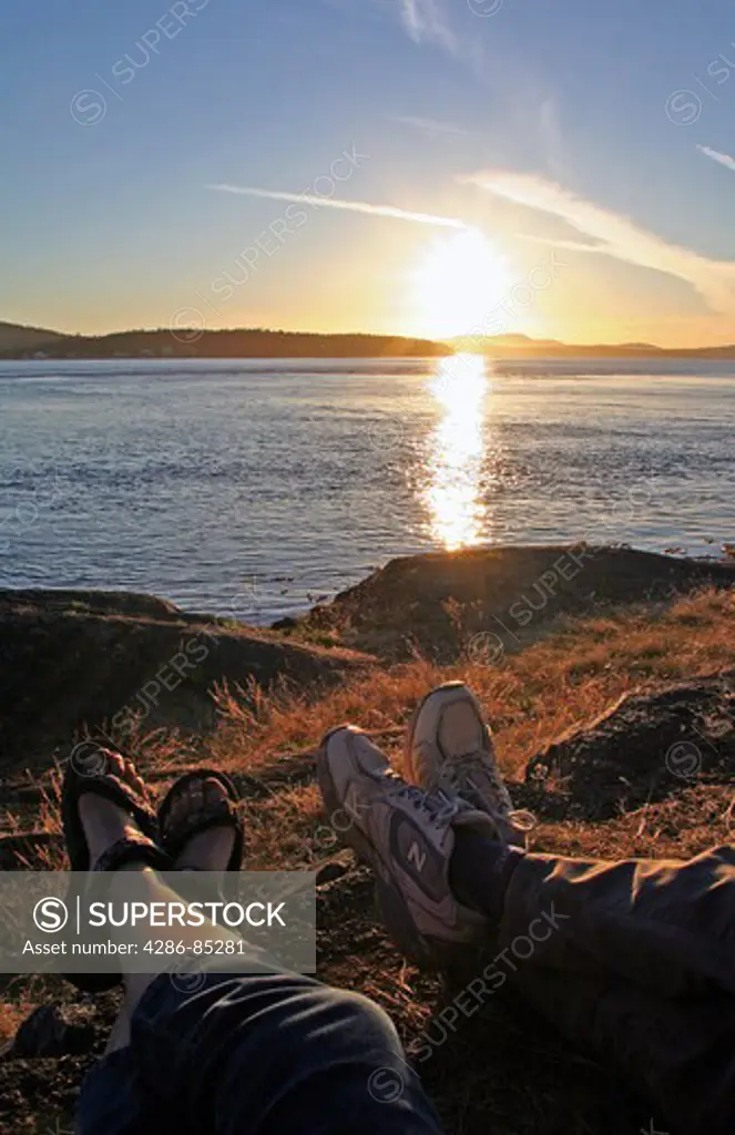 Feet of couple and sunset Lopez Island San Juan Islands Washington