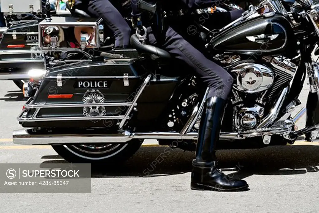 Close up of a police officers legs on a motorcycle