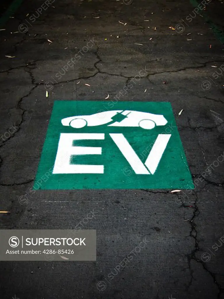 Logo painted in the pavement of a bank parking lot in Atascadero, California that indicates the parking spot is reserved for the charging of electric vehicles only.