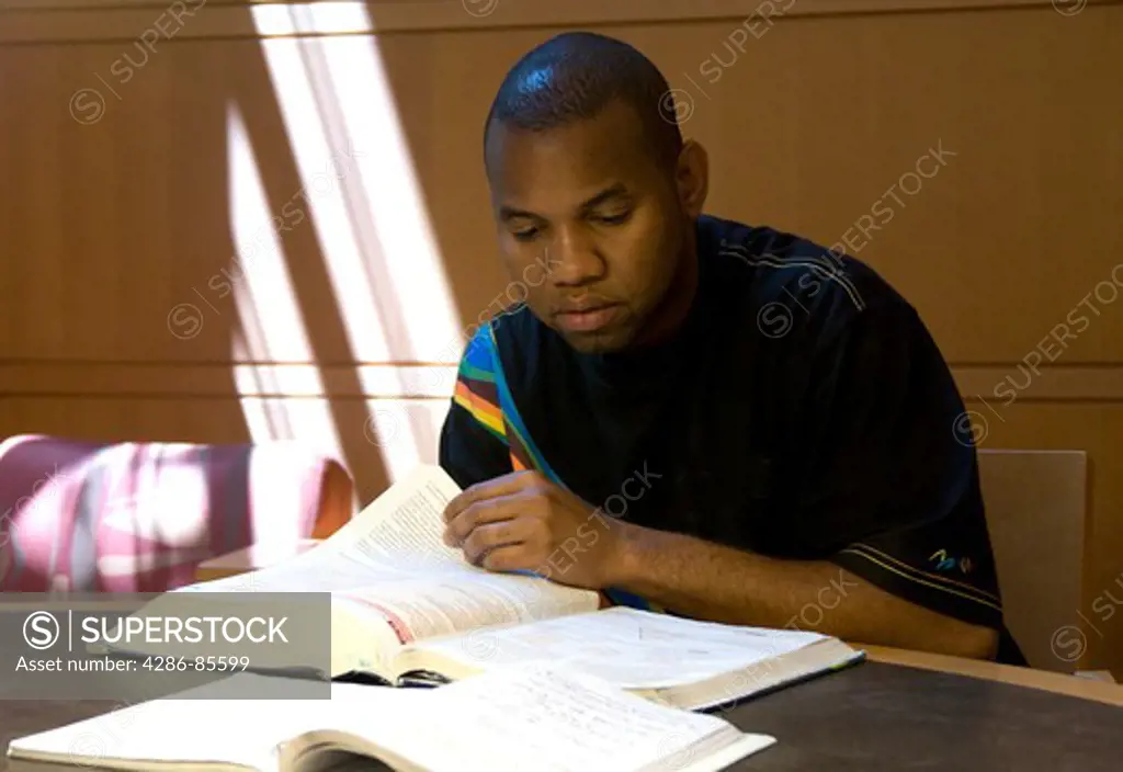 African American man reading and studying