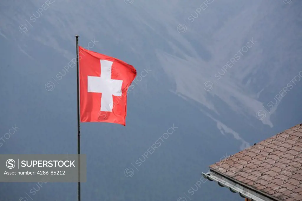Swiss national flag with the Alps background, Switzerland