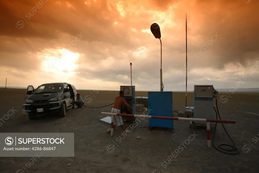 Hand powered petrol station in the Gobi desert, refueling a off-road vehicle, Mongolia
