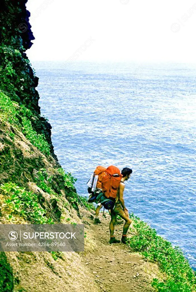 Man hiking on the Na Pali Coast, Kauai, Hawaii