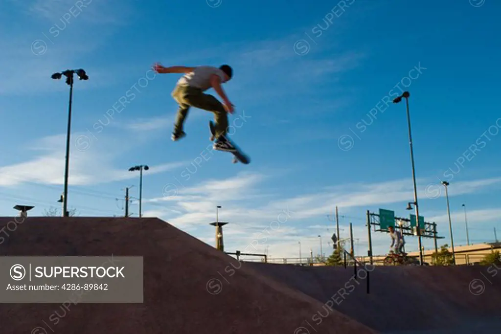 Abstract view of a skateboarder launching in air off a ramp