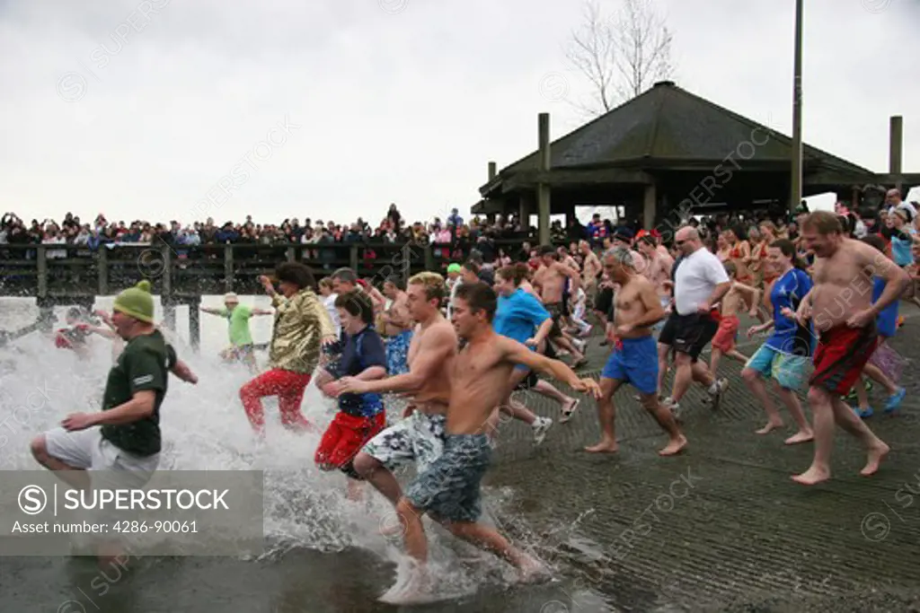 Dozens of adults and children run into the cold ocean at Port Moodys annual Penguin Plunge into Burrard Inlet. The photographer did this as well.