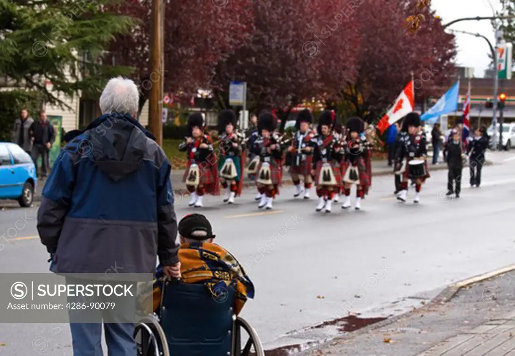 Veteran in wheelchair observes Remembrance Day Parade, Port Coquitlam, BC, Canada