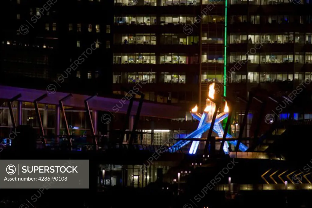Closeup of Lit Olympic Cauldron beside Media Center and Canada Place along the waterfront during the 2010 Winter Olympic Games, Vancouver, Canada