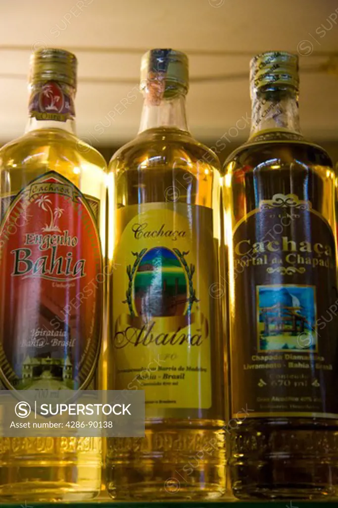 BraziL. Bottles of locally made Cachaca on sale at the indoor market, Salvador, Bahia.