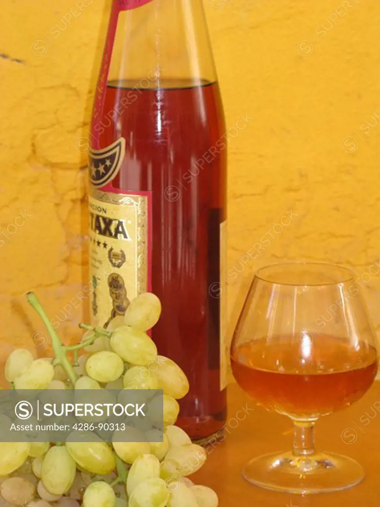 Bottle and glass of Greek Metaxa Brandy.