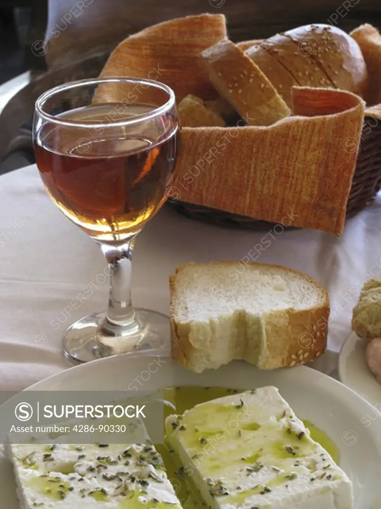Greek Cuisine. Feta cheese in Olive Oil and a glass of red wine. Chania, Crete, Greece
