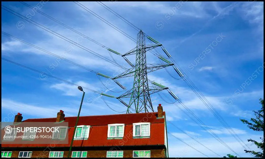 Energy and environment. Overhead electric power over apartment complex. London England.
