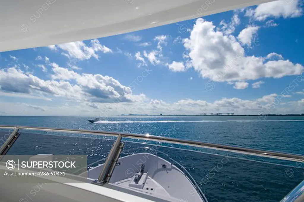 View from luxury power yact of Atlantic Ocean and speeding power boat, Ft. Lauderdale, FL