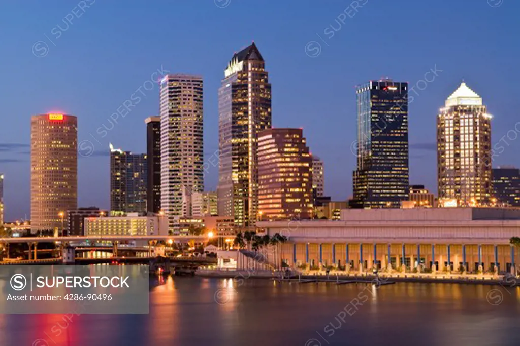 Tampa, Florida, skyline reflects in Tampa Bay at dusk