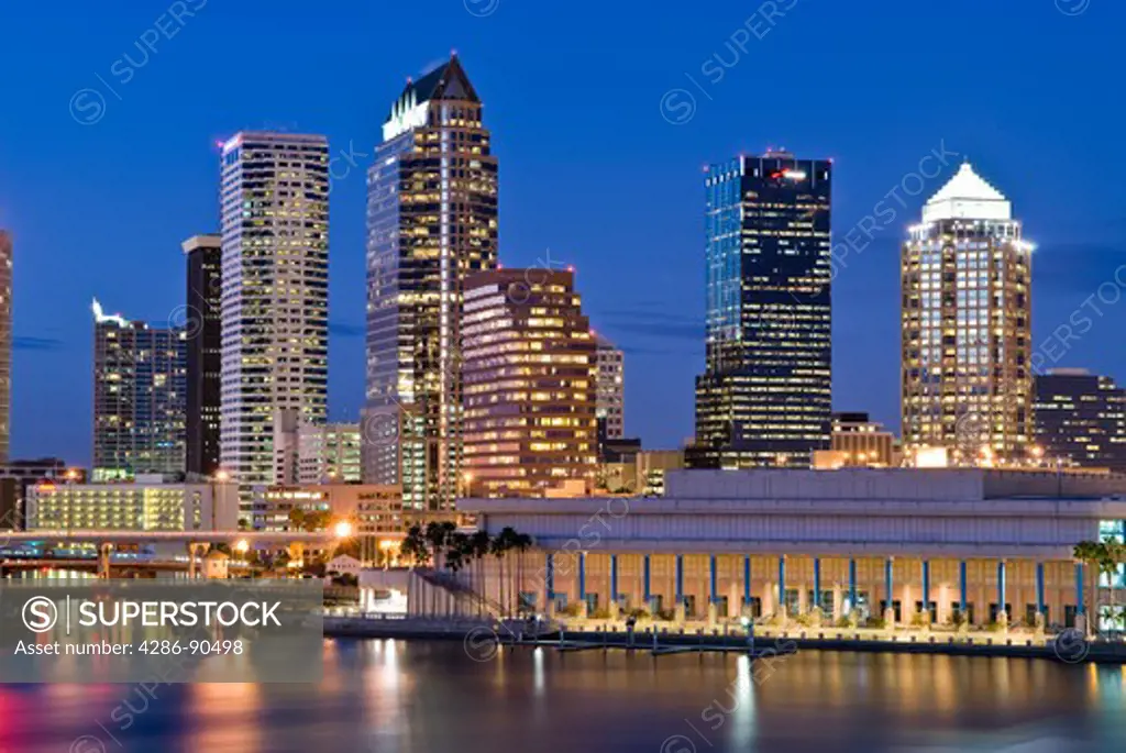 Tampa, Florida, skyline reflects in Tampa Bay at dusk