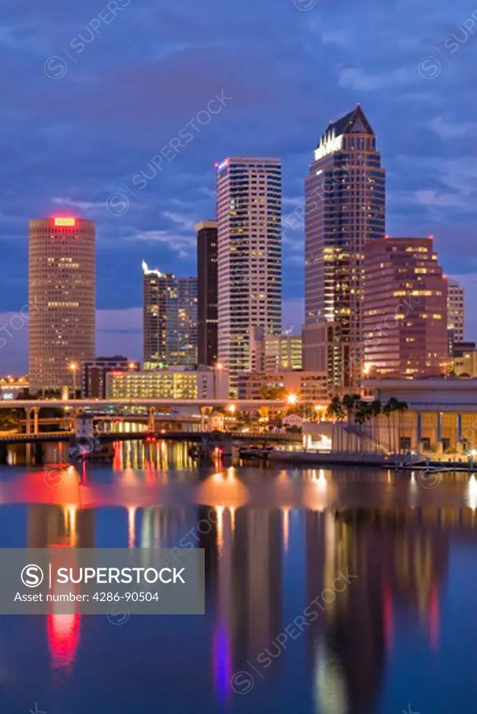 Tampa, Florida, skyline reflects in Tampa Bay at dusk 