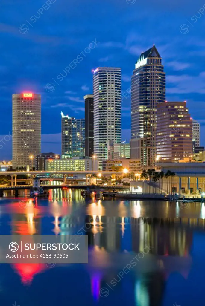 Tampa, Florida, skyline reflects in Tampa Bay at dusk 