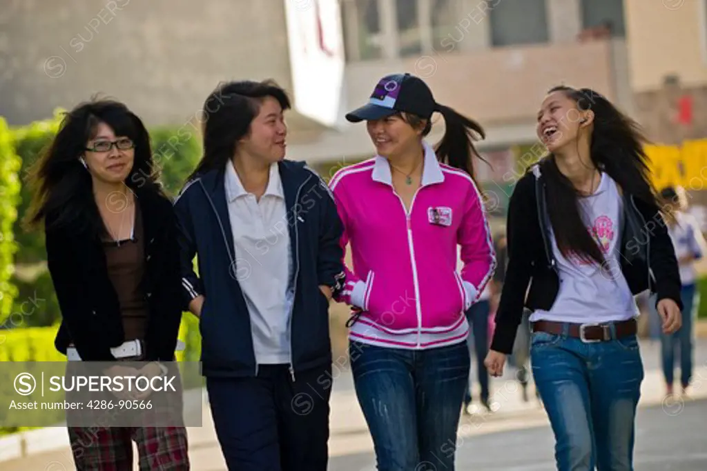 Young women students walk and chat, Quanzhou, Fujian Province, China