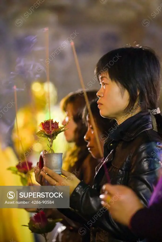 Women offer incense and flowers inside Buddhist temple cave, Yangdang Mountains, Wenzhou, Zheijiang Province, China