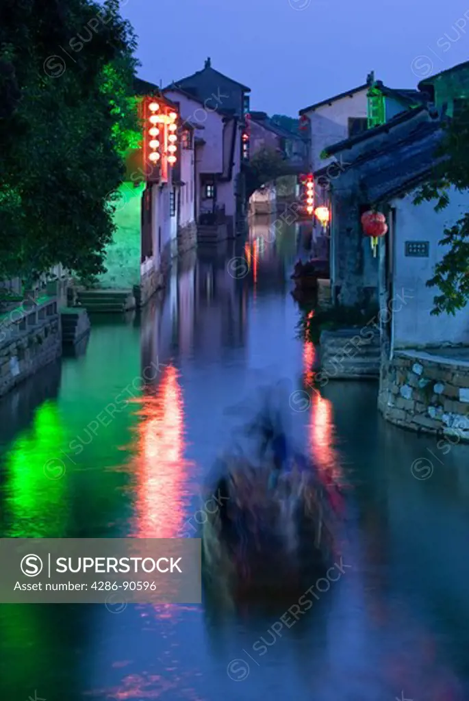 Row boat blurs on canal of water-town, Zhouzhuang, Jiangsu Province, China