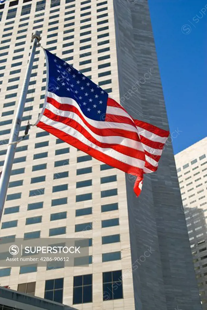 American flag ripples in wind below highrise downtown buildings, Miami, Florida