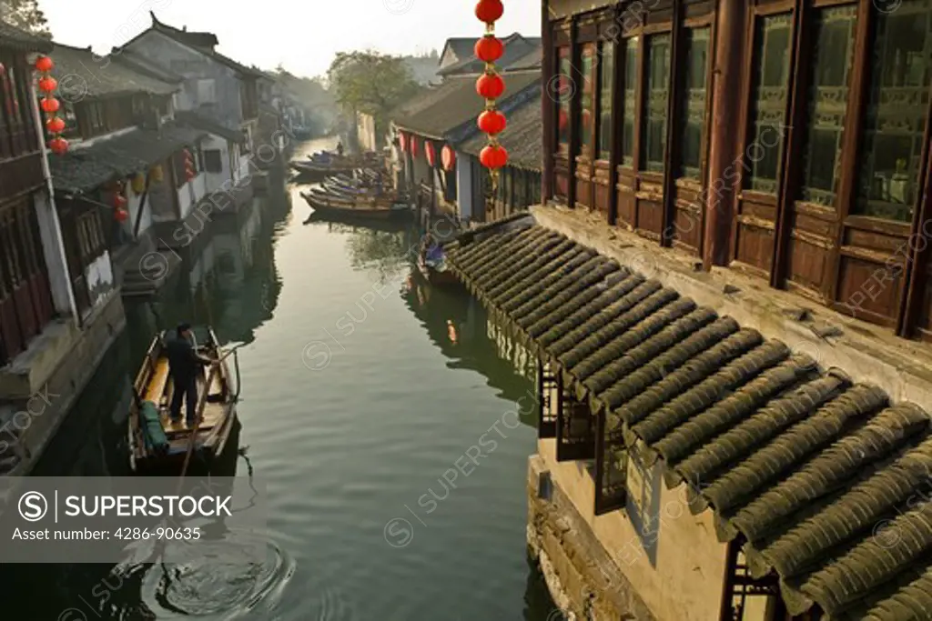 Row boat on canal of historic water town, Zhouzhuang, Jiangsu Province, China