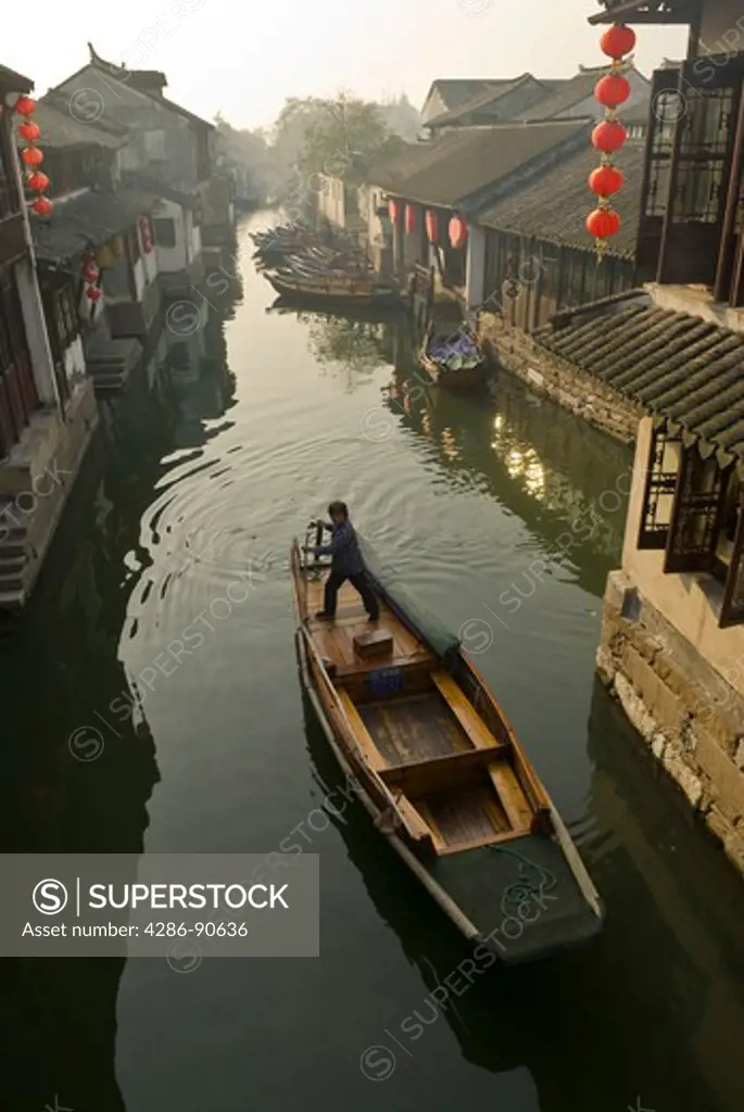 Row boat on canal of historic water town, Zhouzhuang, Jiangsu Province, China 