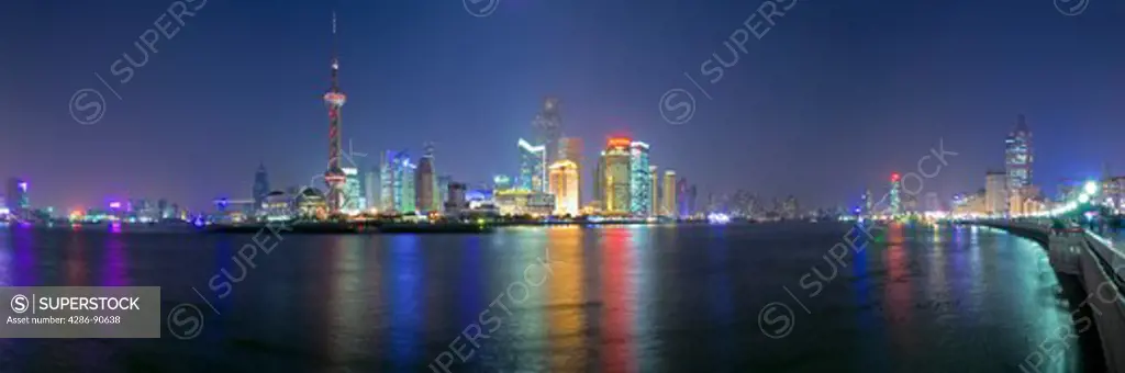 Panoramic night time Pudong district skyline overlooking Huangpu River, Shanghai, China