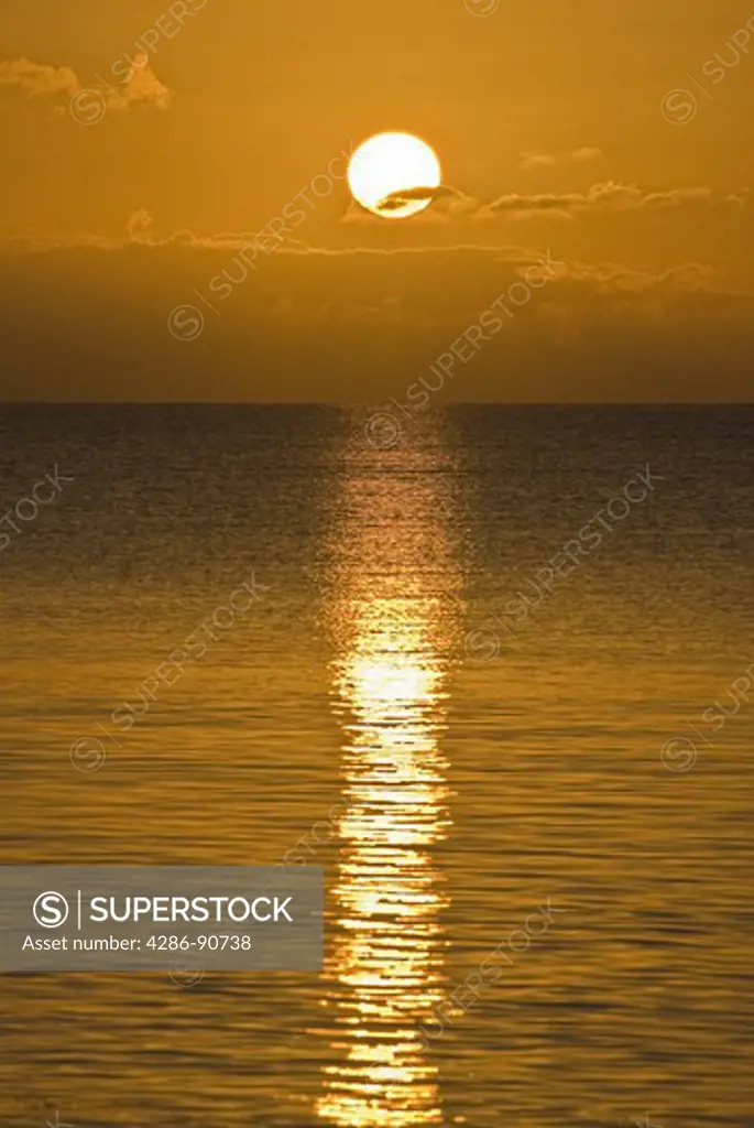 Setting orange sun shimmers over endless ocean, Bahia Honda State Park, Florida Keys, Florida