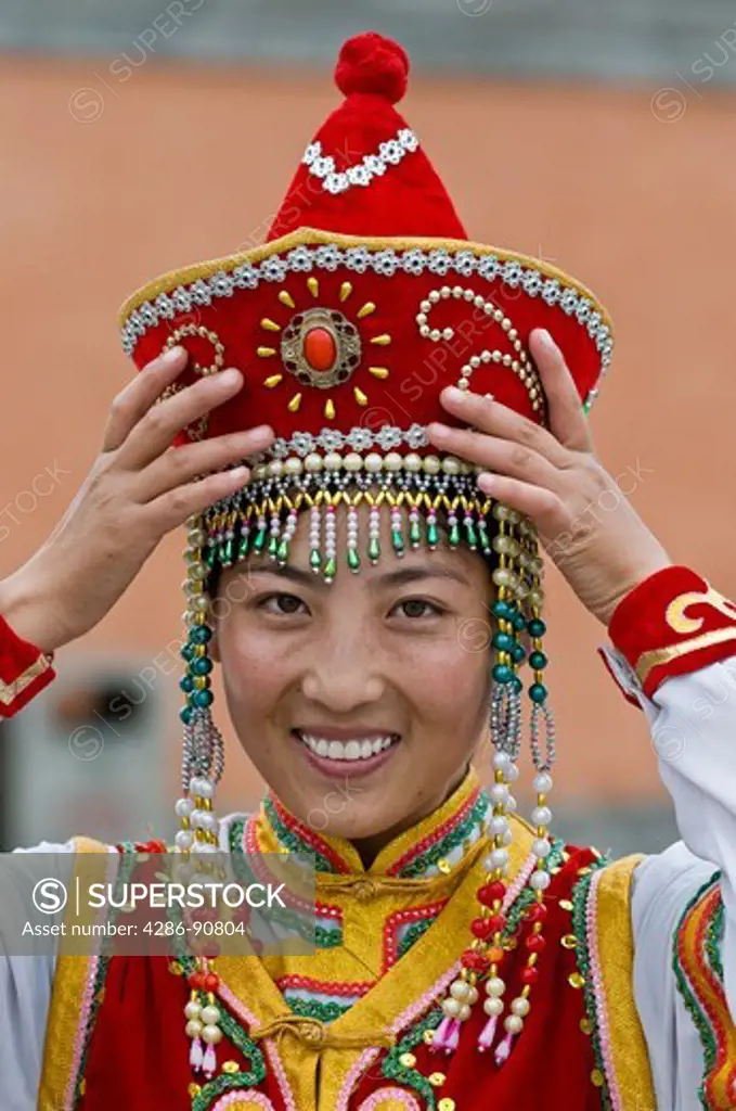 Chinese tourist has her picture taken in ethnic Mongolian costume, Xilinhot, Inner Mongolia, China