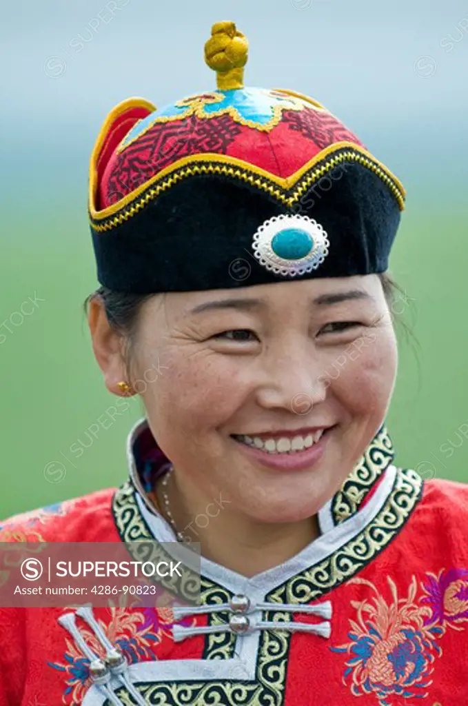 Traditionally dressed ethnic Mongolian attends summertime Naadam Festival, Xiwuzhumuqinqi, Inner Mongolia, China
