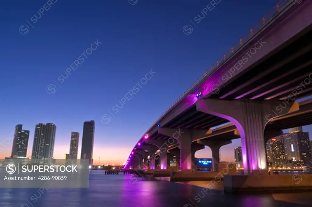 Magenta lights of public art work highlights McArthur Causeway bridge over Biscayne Bay, Miami, Florida