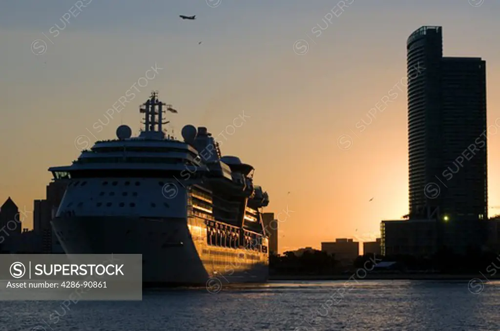Cruise ship lined with passengers watching sunset, Biscayne Bay, Miami, Florida