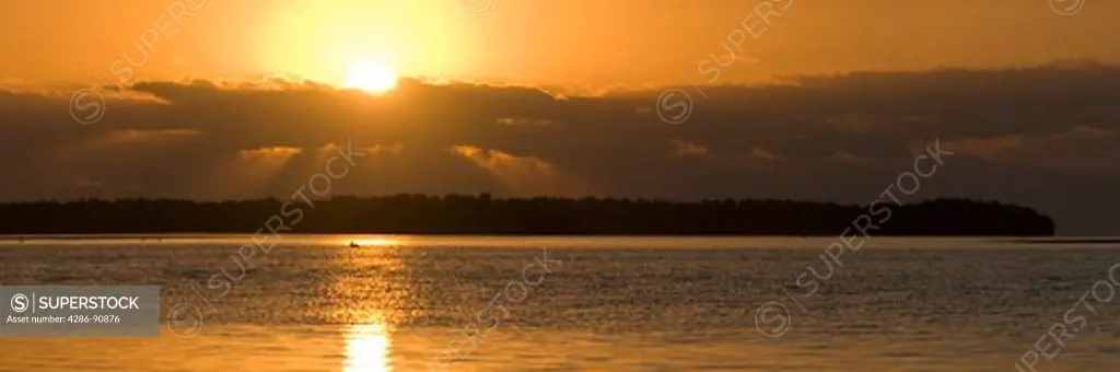 Sun rises through clouds over mangrove islands in Florida Bay, Everglades National Park, Florida