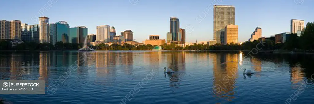 Downtown skyline of Orlando, Florida, reflects in Lake Eola at sunrise