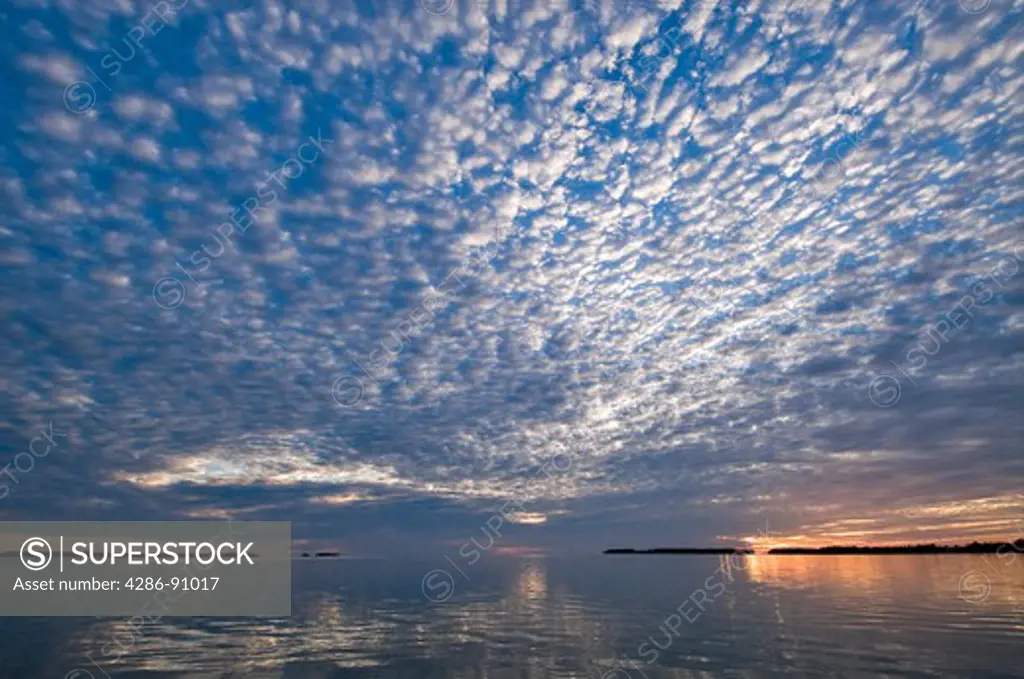 Clouds reflect in smooth Florida Bay at sunset, Flamingo area, Everglades National Park, Florida, USA