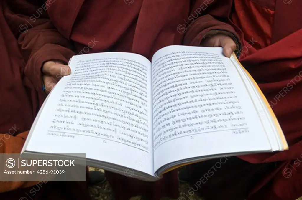 Young Tibetan Buddhist monks hold scriptures after prayers, Juli Monastery, Xinduqiao, Sichuan Province, China