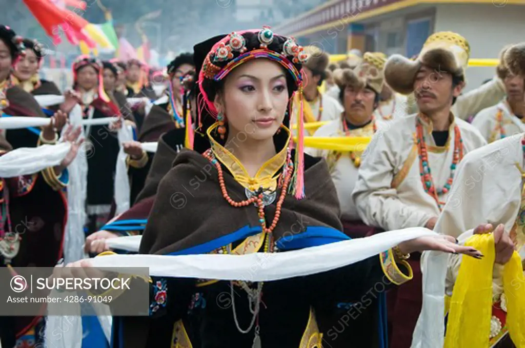 Ethnic Tibetan woman dancer holds scarf at dance and folk festival, Danba, Sichuan Province, China