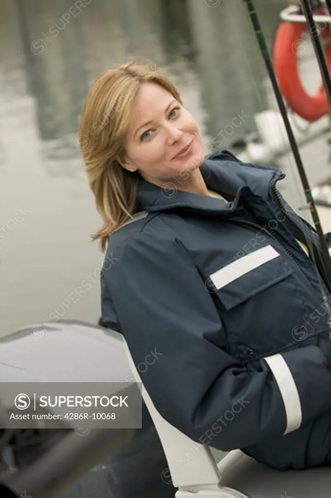 Woman wearing foul weather gear preparing to go fishing  MR-0423 PR-0424