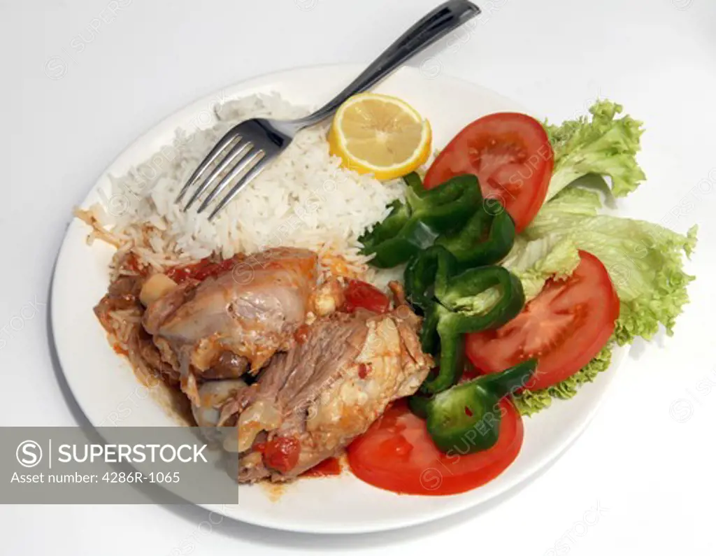 Lamb baked with tomato, served with white rice and a salad