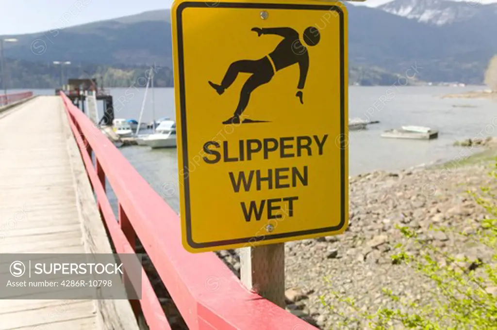 Slippery When Wet sign, New Brighton dock, Gambier Island, Howe Sound, British Columbia Canada.