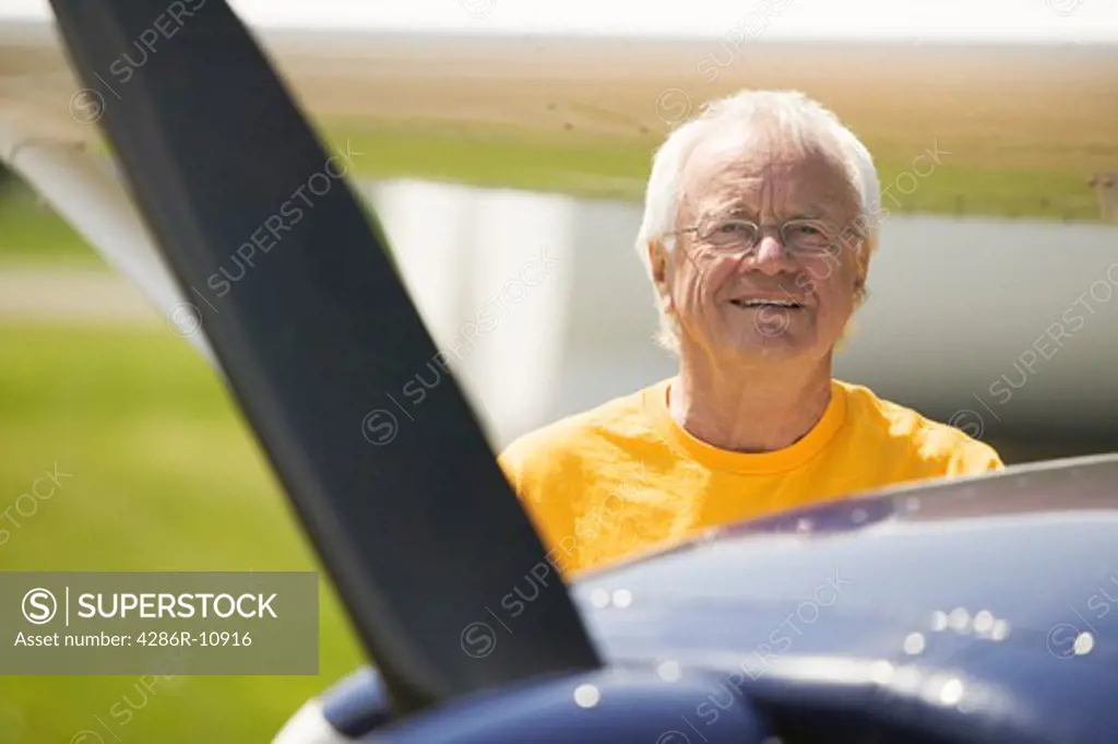 Senior caucasian male with Cessna aircraft.  PR