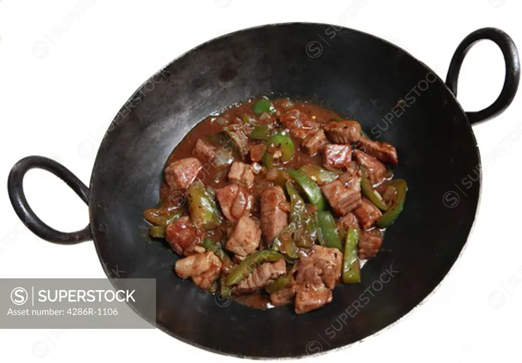 A traditional cast-iron wok containing beef and capsicums in black bean, garlic and ginger sauce, a traditional Cantonese dish.