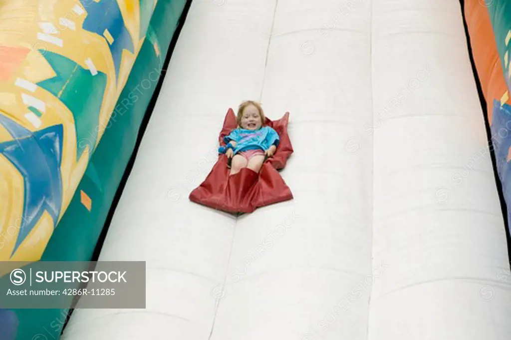 Young girl (3 yrs) on inflatable slide..MR-0501